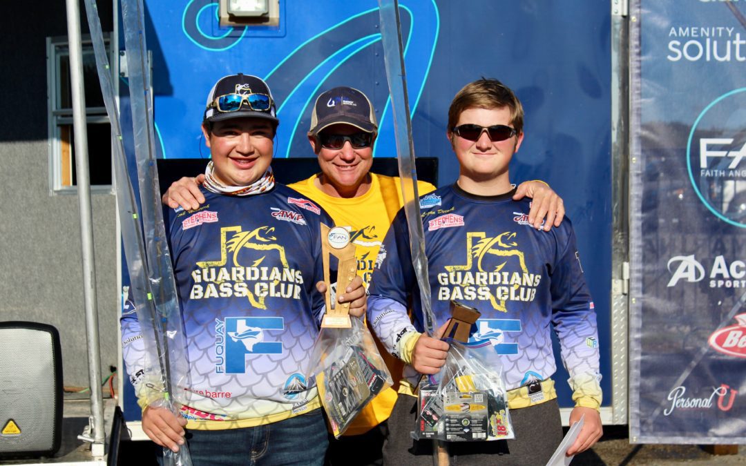 Three men are posing with their trophies in front of a truck.