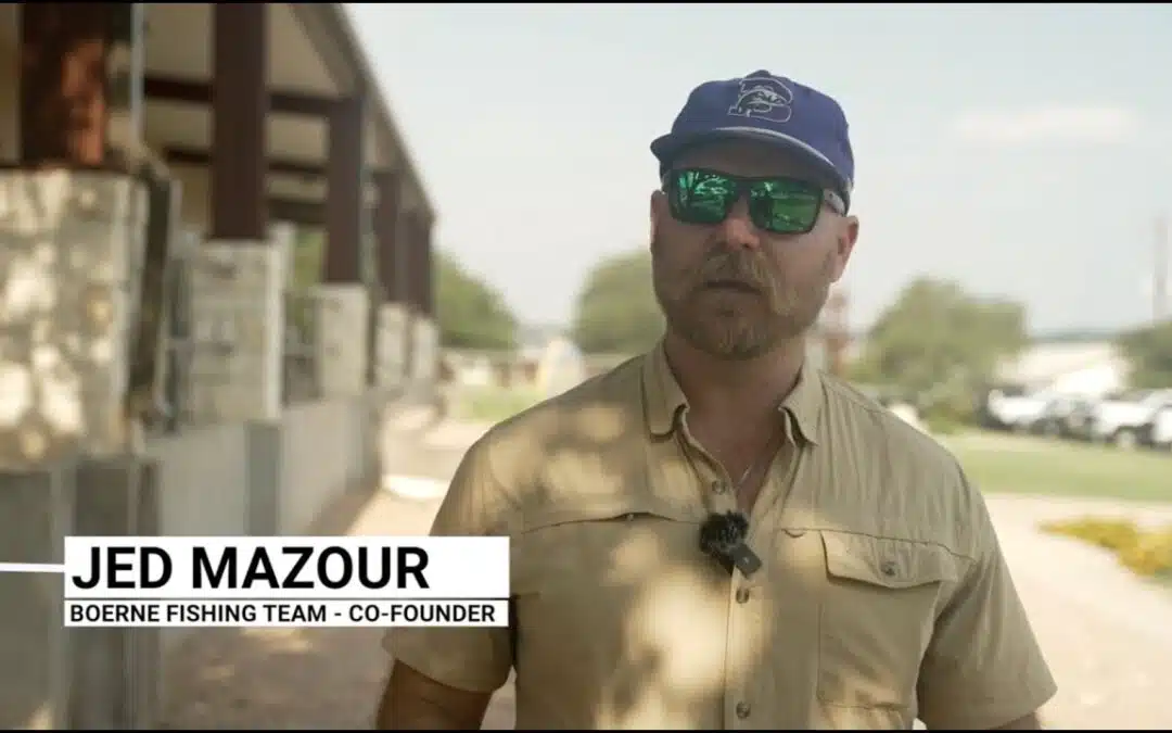 Man outdoors wearing sunglasses and a cap.